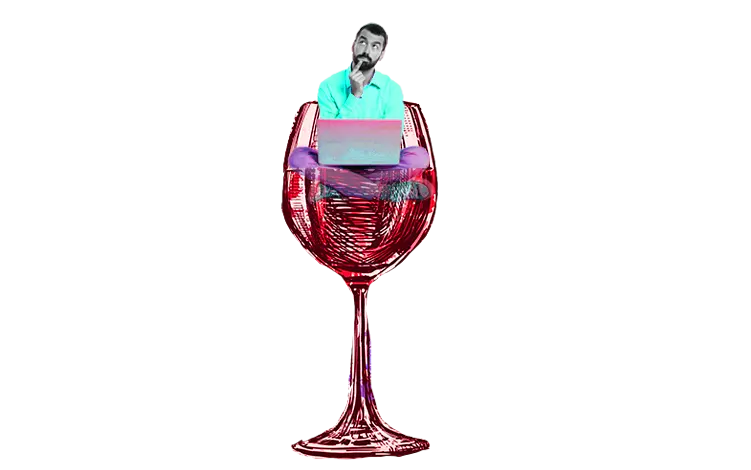 A person sitting and planning on a giant wine glass