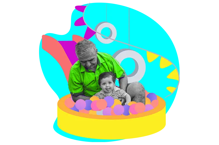Grandfather playing with grandchild in a ball pit